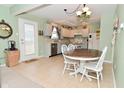 Eat-in kitchen featuring white cabinetry, stainless steel dishwasher, and a round dining table at 8317 S Swimming Hole Ln, Pendleton, IN 46064