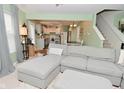 Inviting living room with gray sectional sofa, open to the kitchen and dining area at 8317 S Swimming Hole Ln, Pendleton, IN 46064