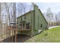 Exterior view featuring a spacious deck ideal for entertaining and surrounded by lush greenery at 1032 E Woodall Ct, Martinsville, IN 46151