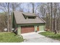 Charming home with a garage and inviting deck, nestled in a beautiful, wooded area at 1032 E Woodall Ct, Martinsville, IN 46151