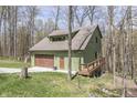 Charming home with a garage, inviting deck and surrounded by a beautiful, wooded area at 1032 E Woodall Ct, Martinsville, IN 46151