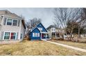 A charming blue two-story home featuring a cozy front porch and well-maintained lawn at 1038 W 33Rd St, Indianapolis, IN 46208