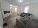Modern living room with gray sectional sofa, stylish rug, and sleek fireplace at 1038 W 33Rd St, Indianapolis, IN 46208