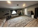A view of the living room from the opposite angle highlighting the gray walls and comfortable furniture at 1130 W State Road 42, Mooresville, IN 46158