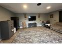 A living room with gray walls and a patterned rug featuring a dark entertainment center and two safes at 1130 W State Road 42, Mooresville, IN 46158