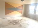 Spacious bedroom with geometric accent wall and natural light from large window at 11423 Mutz Cir, Indianapolis, IN 46229