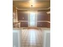 Dining room with tiled floor, traditional trim, and view of backyard through door at 11423 Mutz Cir, Indianapolis, IN 46229