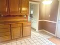 Kitchen with wooden cabinets and adjacent breakfast nook at 11423 Mutz Cir, Indianapolis, IN 46229
