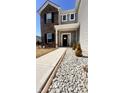 Inviting front entrance with stone landscaping, walkway, and charming front door decor at 1456 Bigleaf Dr, Sheridan, IN 46069