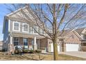 Lovely two-story home with a combination of brick and siding, complemented by a spacious front yard at 15296 Ellington Dr, Fortville, IN 46040