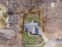 Aerial view showcasing the property's layout within a wooded neighborhood setting at 15921 Herriman Blvd, Noblesville, IN 46060