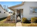 Inviting front porch with ceiling fan, seating, and view of the landscaped yard at 234 S East St, Pendleton, IN 46064
