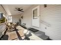 Covered porch with ceiling fan, seating area, and entryway to home at 234 S East St, Pendleton, IN 46064