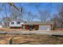 Charming two-story home featuring brick and siding accents, an attached garage, and a well-maintained front yard at 24535 Jerkwater Rd, Sheridan, IN 46069