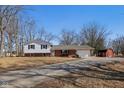 A beautiful home featuring a red barn with expansive land and a long driveway to the white and brick home at 24535 Jerkwater Rd, Sheridan, IN 46069