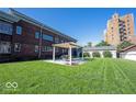 Expansive backyard with lush green lawn, covered patio, and detached garage at 3034 N Pennsylvania St # 1, Indianapolis, IN 46205