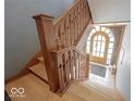 Grand foyer with hardwood floors and ornate wooden staircase leading to upper level at 3034 N Pennsylvania St # 1, Indianapolis, IN 46205
