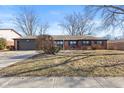 Classic brick house with an attached garage, a well-kept front yard, and symmetrical landscaping along the side at 429 Southmore St, Plainfield, IN 46168