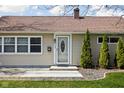 Welcoming front entrance with decorative glass door and neat landscaping, creating curb appeal at 506 Carol Dr, Greenwood, IN 46143