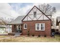 A delightful brick home boasting a charming porch and Tudor-style architectural details at 6189 Primrose Ave, Indianapolis, IN 46220