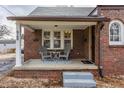 Inviting front porch with seating area, perfect for relaxing and enjoying the neighborhood at 6189 Primrose Ave, Indianapolis, IN 46220