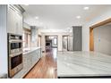 Open-concept kitchen with stainless steel oven and microwave, sleek counter tops, hardwood floors, and ample natural light at 690 N 600 W, Lebanon, IN 46052