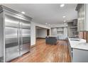 Modern kitchen featuring stainless steel appliances, sleek gray cabinetry, island and hardwood floors at 690 N 600 W, Lebanon, IN 46052