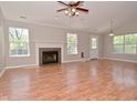 Bright living room with hardwood floors, a fireplace, and large windows at 7101 Thousand Oaks Ln, Indianapolis, IN 46214