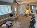 Cozy living room featuring a neutral sofa, and bright natural light from a large window at 724 Center St, Franklin, IN 46131