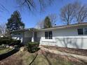 An inviting front entry with well-maintained landscaping and a freshly painted facade at 7406 E 33Rd St, Indianapolis, IN 46226