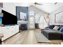 Inviting living room with a fireplace, vaulted ceiling, lots of natural light, and modern decor at 7779 Harbour # 51, Indianapolis, IN 46240