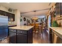 Spacious kitchen open to the dining area with dark wood cabinets, granite countertops, and stainless steel appliances at 8416 Whitaker Valley Blvd, Indianapolis, IN 46237