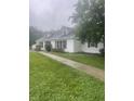 Beautifully landscaped front yard with a sidewalk leading to a charming white brick home at 8888 Cholla Rd, Indianapolis, IN 46240