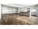 Open-concept layout of this living room featuring hardwood floors and seamless access to the adjacent kitchen at 8888 Cholla Rd, Indianapolis, IN 46240