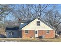 Back of home showing a brick foundation and white siding, plus a new exterior door and an air conditioning unit at 8888 Cholla Rd, Indianapolis, IN 46240