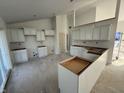 Spacious kitchen featuring white cabinets and large center island under construction at 103 N Brenrich Rd, Pendleton, IN 46064