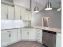 Close-up of a kitchen with white cabinets, granite countertops, and stainless appliances at 103 N Brenrich Rd, Pendleton, IN 46064