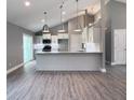 Bright kitchen with white cabinets, stainless appliances, and a granite countertop island at 103 N Brenrich Rd, Pendleton, IN 46064