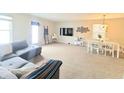 Bright and airy living space featuring comfortable seating and a cozy atmosphere with seamless connection to the dining area at 10921 Walnut Grv, Camby, IN 46113