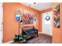 Inviting entryway featuring a wooden bench, decorative artwork, and a plant at 11077 Ellsworth Ln, Fishers, IN 46038