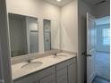 Bathroom boasts double sinks with a light countertop and a shower, creating a functional space at 1414 Bluebonnet Pl, Shelbyville, IN 46176