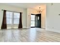 Inviting living room featuring vinyl floors and large windows that let in ample sunlight at 1427 Broyles Ln, Indianapolis, IN 46231