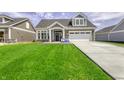 Inviting home with a manicured lawn and attached two-car garage at 16822 Imperial Ct, Fishers, IN 46040