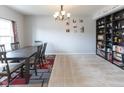 Bright dining room with a large table, elegant chandelier, and a built-in bookcase at 1763 Wedgewood Pl, Avon, IN 46123
