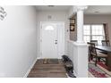 Warm and welcoming foyer featuring stylish flooring, a white front door, and easy access to the dining area at 1763 Wedgewood Pl, Avon, IN 46123