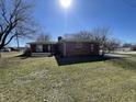 Exterior shot showing the backyard with a patio, perfect for outdoor relaxation and entertainment at 2130 Theobald St, Shelbyville, IN 46176