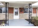Close-up of the front porch with decorative iron supports and brick detailing at 226 N 8Th Ave, Beech Grove, IN 46107