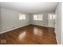 Bright living room with gleaming hardwood floors and neutral paint at 226 N 8Th Ave, Beech Grove, IN 46107