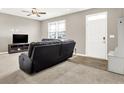 Inviting living room with neutral walls, carpet, a ceiling fan, and a view of the front door at 2792 Maricopa Blvd, Whitestown, IN 46075