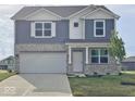 Charming two-story home with a stone and siding exterior and well-maintained landscaping at 2976 W Tapestry Dr, Monrovia, IN 46157